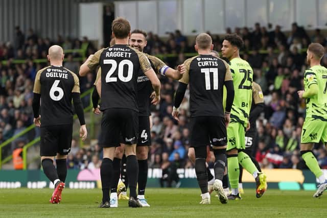 Sean Raggett is congratulated by his Pompey team-mates following his 17th-minute opener