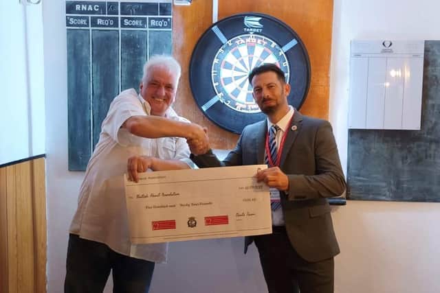 Members of the Waterlooville Royal Naval Association raise £534 for the British Heart foundation, received by David Whitaker, manager of the Waterlooville shop.