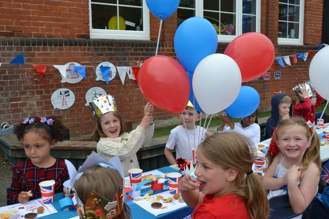 Pupils enjoying a Platinum Jubilee street party in the playground of Devonshire Infant School, Southsea