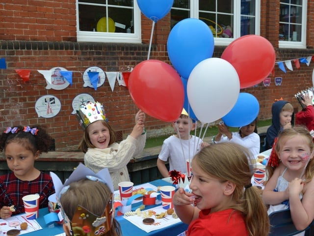 Pupils enjoying a Platinum Jubilee street party in the playground of Devonshire Infant School, Southsea