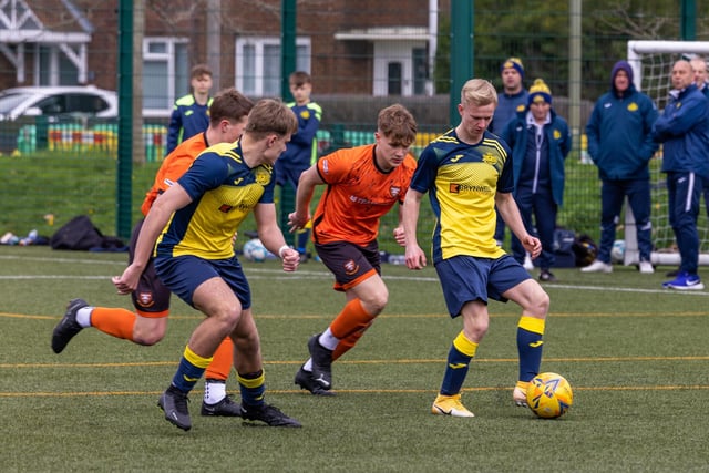 Action from the 2-2 draw between the under-18s of Moneyfields (blue/yellow kit) and AFC Portchester (orange/black kit). Picture: Mike Cooter