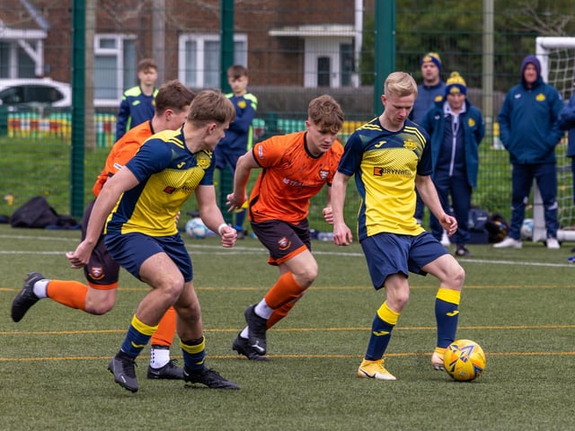 Action from the 2-2 draw between the under-18s of Moneyfields (blue/yellow kit) and AFC Portchester (orange/black kit). Picture: Mike Cooter