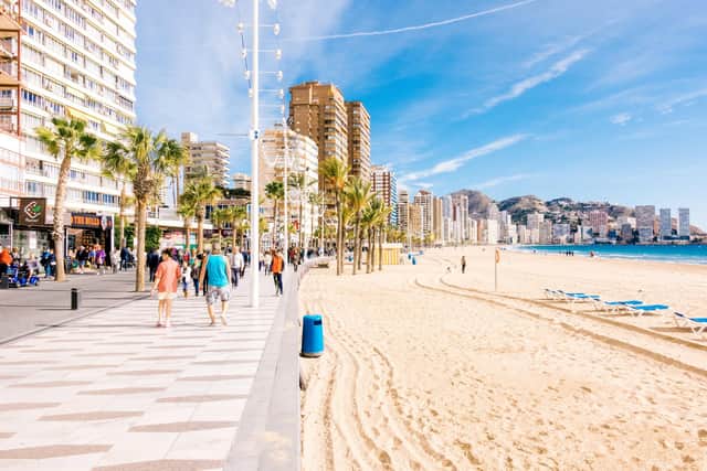 Families walking along the beach in Benidorm
