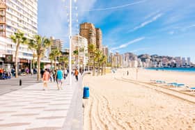 Families walking along the beach in Benidorm