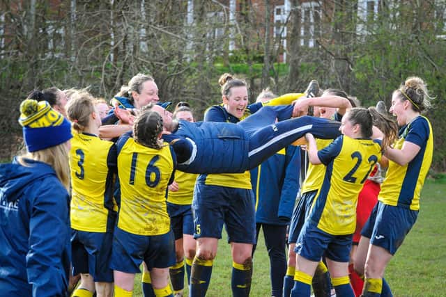 Moneyfields Women manager Karl Watson is hoisted in the air by his players after the club's title win last month