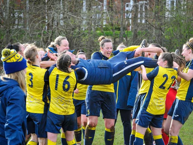 Moneyfields Women manager Karl Watson is hoisted in the air by his players after the club's title win last month