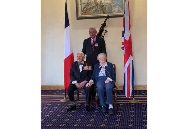 Dennis Cooper from Portsmouth, left, with his wife Mary and SSAFA case worker Nick Bates as he is awarded the Legion D'honneur for his D-Day bravery. Picture: SSAFA/PA Wire