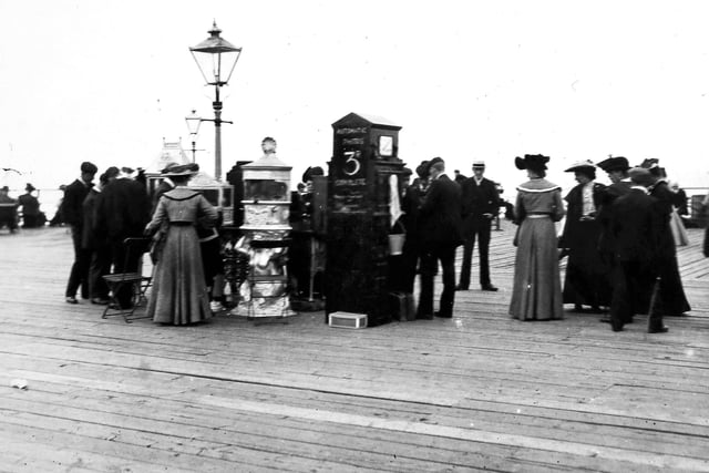An automatic photo booth in Southsea circa 1900. (Photo by F. J. Mortimer/Hulton Archive/Getty Images)