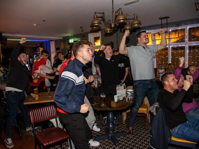 Fans celebrate England scoring against Senegal. Photos by Alex Shute