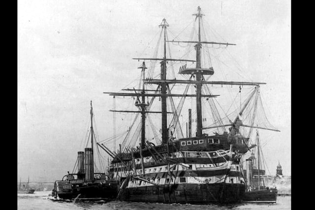 De-masted three decker in Portsmouth Harbour.This marvellous photograph of a Nelsonian/Napolionic wooden wall was loaned to us by William Tofts of Copnor. We don't believe it's HMS Victory, but could be. The steam tugs are assisting alongside.