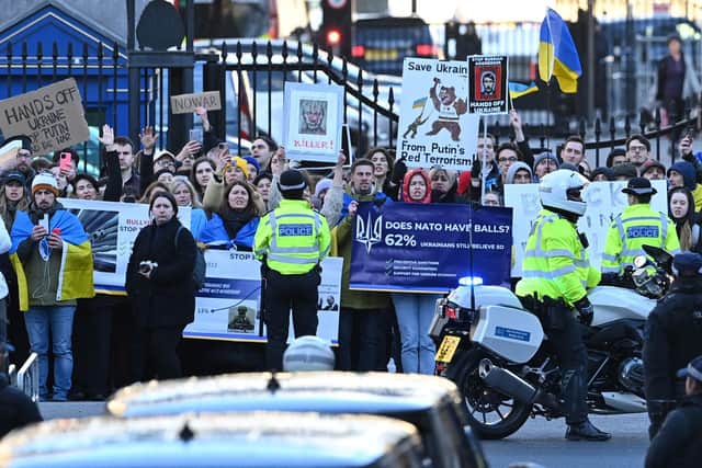 Protesters waving Ukrainian flags greet Boris Johnson as he leaves from 10 Downing Street to make a statement, to the House of Commons. Photo by Justin Tallis /AFP via Getty Images