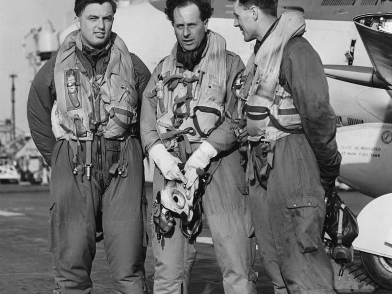 L-R, Lieutenants D Lang, D Price and D Rawbone, pilots of Fleet Air Arm 800 Squadron Supermarine Attacker FB2 fighters after landing on the flight deck of HMS Eagle during exercises in the English Channel on 19 March 1952.