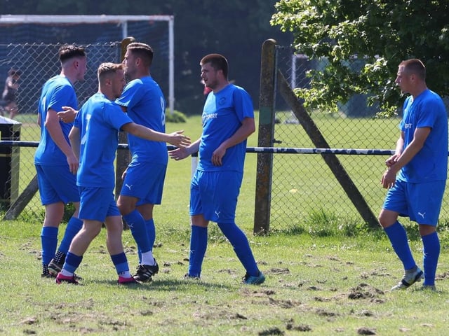 Joe Boxall (blue) has just scored Paulsgrove's winner against Clanfield. Picture: Sam Stephenson.