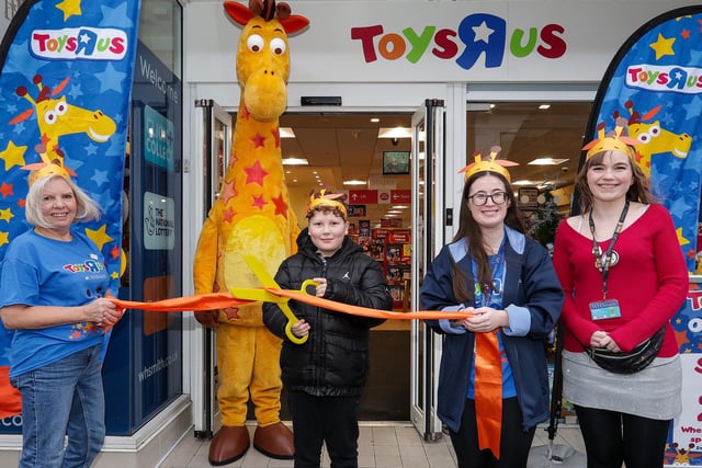 Lewis Harry, 8, who was first in the queue, cuts the ribbon, with manager Bryony Waldron, right, and other staff at the opening of Toys R Us shop in WHSmith, West Street, Fareham Picture: Chris  Moorhouse (231124-09)