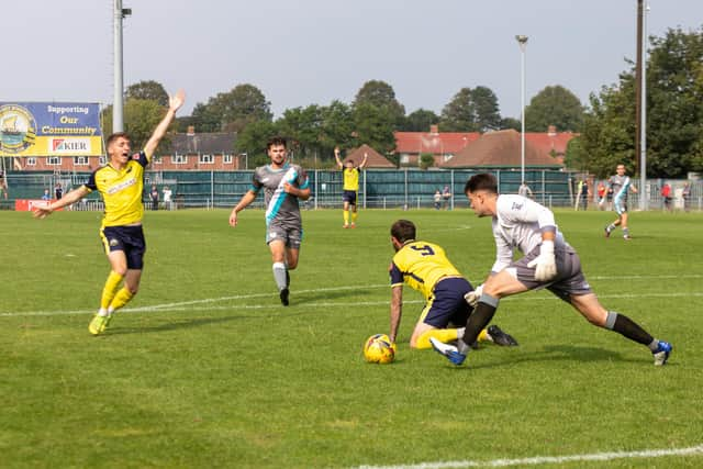 Parkway goalkeeper Kyle Moore concedes a penalty by bringing down Dan Wooden. Picture: Mike Cooter