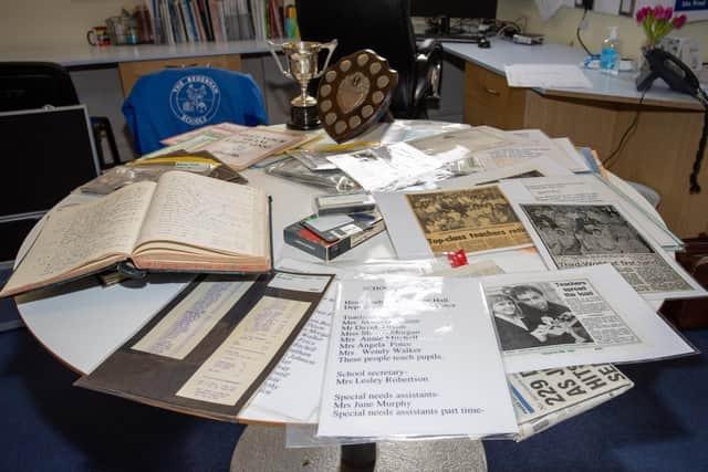 Some of the items in the capsule. Nearly 30 years after it was buried away for a future generation to find, the metal case of historic items was discovered hidden in a block of concrete at Bedenham Primary School. Inside the time capsule, staff discovered trophies, photographs, newspaper clippings, log books, old receipts, merit badges, staff lists, certificates, and sports kits - and even a 1996 copy of the Gosport edition of The News.The items inside the capsule date from years between 1948 and 1996, with objects dated from the 70s and 80s.Picture: Alex Shute