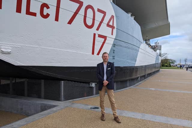 Nick Hewitt, head of collections and research at The National Museum of the Royal Navy, next to the LCT 7074. Picture: Emily Turner