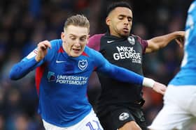 Ronan Curtis battles with Nathan Thompson during Pompey's 2-2 draw with Peterborough in December. Picture: Joe Pepler
