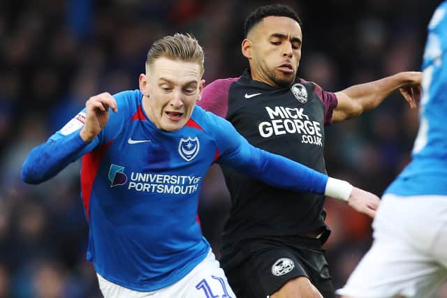 Ronan Curtis battles with Nathan Thompson during Pompey's 2-2 draw with Peterborough in December. Picture: Joe Pepler
