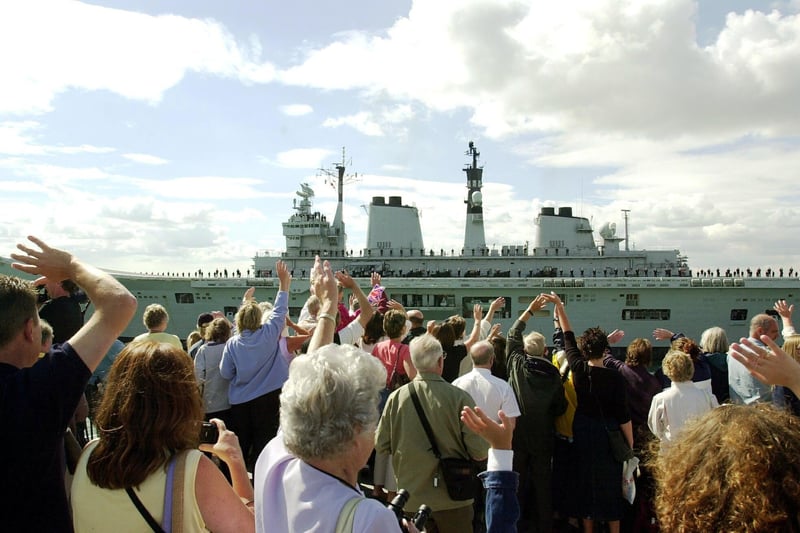 Friends and family wave HMS Illustrious off as she heads for the Gulf from Portsmouth. Picture: Luke MacGregor 014607-1