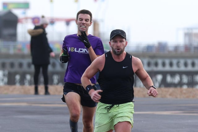 Tristam Murdoch  (yellow shorts) beats Sam Taylor-Allkins to finish first in the Southsea parkrun. Photograph by Sam Stephenson