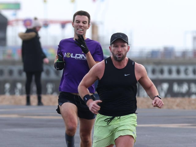 Tristam Murdoch  (yellow shorts) beats Sam Taylor-Allkins to finish first in the Southsea parkrun. Photograph by Sam Stephenson