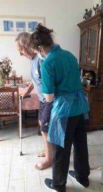 Mark taking some of his first steps after being paralysed for weeks.