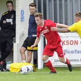 Miles Everett in FA Cup action for Horndean (red) against Melksham in 2017. Non-league clubs will be playing for reduced cash prizes in next season's tournament. Picture Ian Hargreaves
