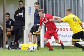 Miles Everett in FA Cup action for Horndean (red) against Melksham in 2017. Non-league clubs will be playing for reduced cash prizes in next season's tournament. Picture Ian Hargreaves