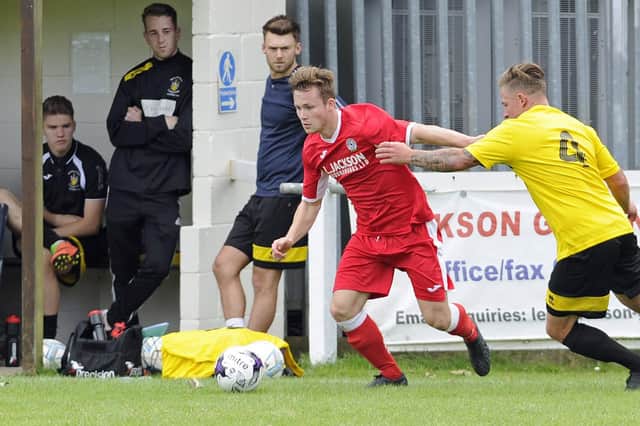 Miles Everett in FA Cup action for Horndean (red) against Melksham in 2017. Non-league clubs will be playing for reduced cash prizes in next season's tournament. Picture Ian Hargreaves