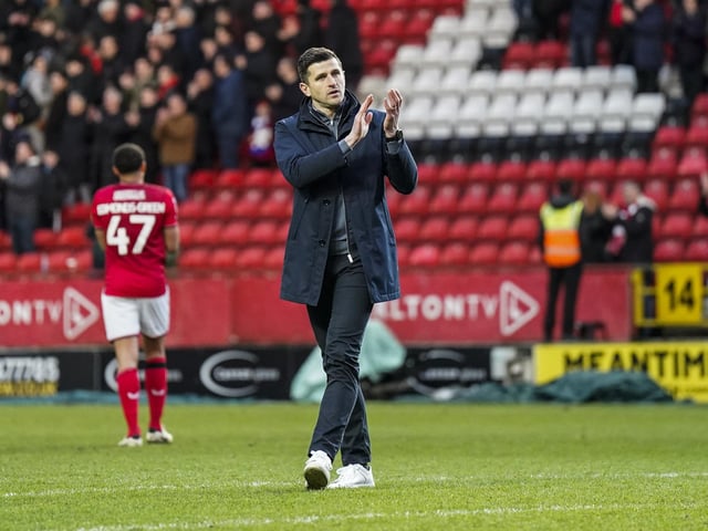 Pompey boss John Mousinho applauds the travelling Fratton faithful at the final whistle.