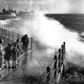 November 1938:  People watching the huge seas breaking over Portsmouth Harbour.  (Photo by David Savill/Topical Press Agency/Getty Images)