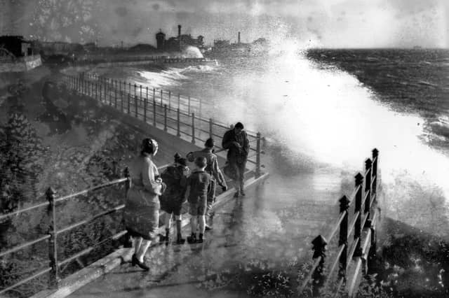 November 1938: People watching the huge seas breaking over Portsmouth Harbour. (Photo by David Savill/Topical Press Agency/Getty Images)