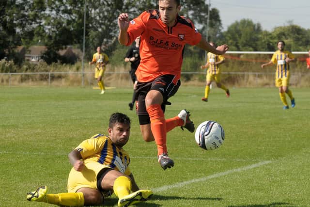 Pete Castle, playing for Sholing, tackles new Portchester colleague Alex Baldicchino during a Wessex League game in 2015. Pic Mick Young