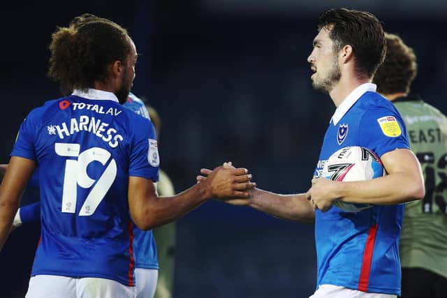 John Marquis congratulates Marcus Harness after scoring his first goal for Pompey against Colchester. Picture: Joe Pepler
