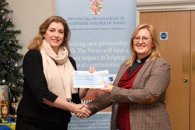 Pictured is: Penny Mourdant MP presents a cheque to the Cosham Larder and the Rev. Amy Webb.

Picture: Keith Woodland (041221-29)