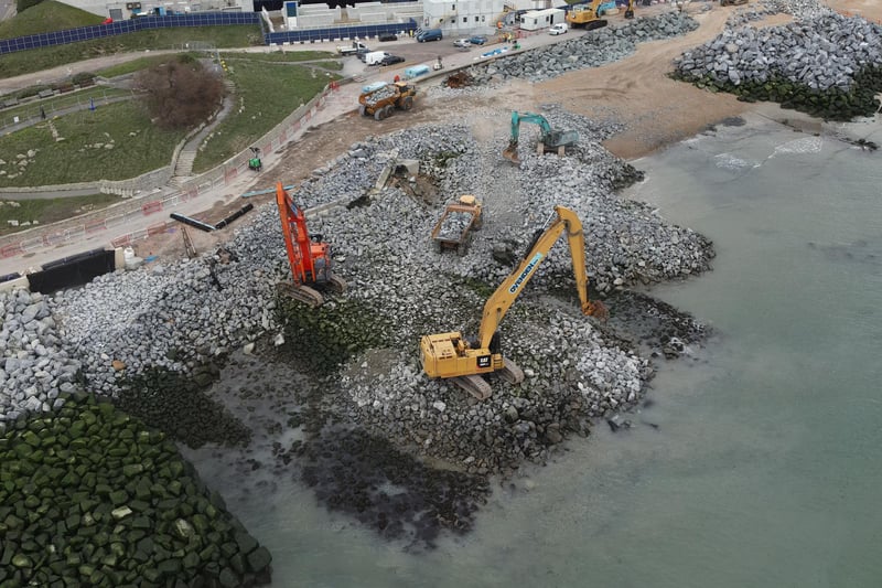 The base layer of the rock groyne is being installed