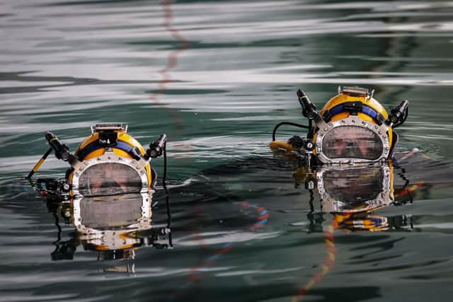 Royal Navy Divers are carrying out work on the hull of HMS Prince of Wales amid a major shake-up of how the service operates