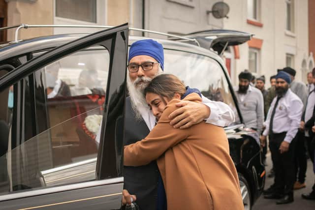 Funeral of Gurbux Singh Bhakar on Friday 4th August 2023. Pictured: Family members comforting each other at Sikh temple, Guru Nanak Sar Gurdwara, Southsea Portsmouth. Picture: Habibur Rahman
