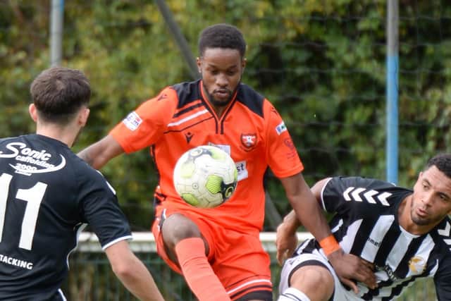 Rudi Plummer is closely watched on his AFC Portchester debut against Bemerton. Pic: Martyn White.