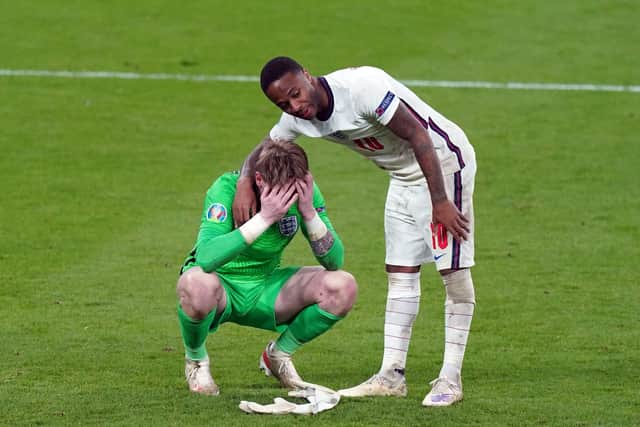England goalkeeper Jordan Pickford stands dejected with Raheem Sterling following the UEFA Euro 2020 Final at Wembley Stadium, London. Picture: Mike Egerton/PA Wire