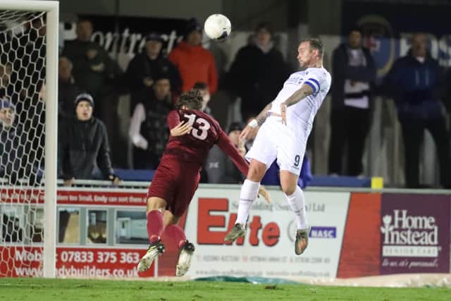 Danny Kedwell rises high against Slough Town. Photo by Dave Haines