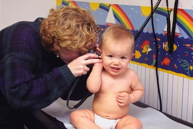 A paediatrician examining an infant at nine months of age. Image: Unsplash