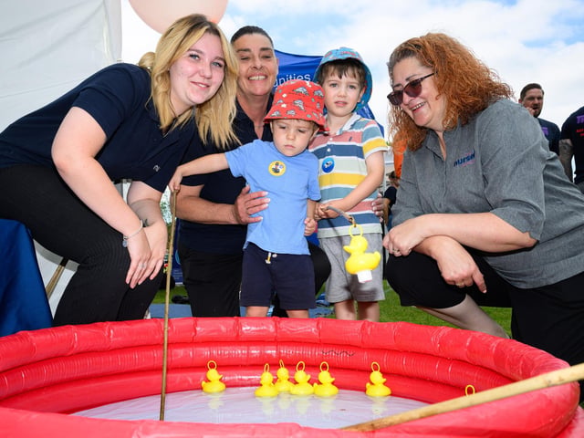 Pictured is: Tyler and Harvey Rogan with the staff The Nursery Family, PurbrookPicture: Keith Woodland (230621-60)