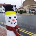 A woollen snowman keeps a bollard warm on Tangier Road