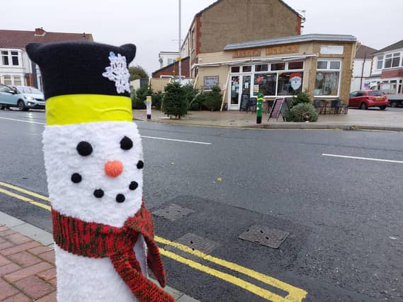 A woollen snowman keeps a bollard warm on Tangier Road