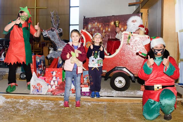 Ruby and Rex Stanbridge with Father Christmas after dropping their gifts off.

Picture: Keith Woodland (121220-2)