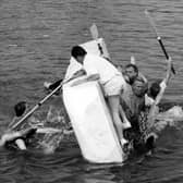 Swimming sabateurs overturn the Rose and Crown polystyrene raft, at the charity raft races at Hardway, Gosport in 1995. The News PP5164