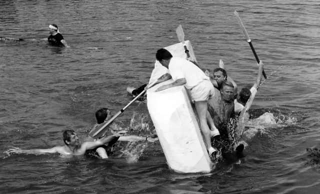 Swimming sabateurs overturn the Rose and Crown polystyrene raft, at the charity raft races at Hardway, Gosport in 1995. The News PP5164