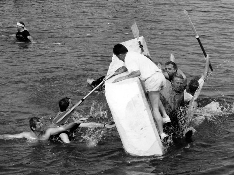 Swimming sabateurs overturn the Rose and Crown polystyrene raft, at the charity raft races at Hardway, Gosport in 1995. The News PP5164